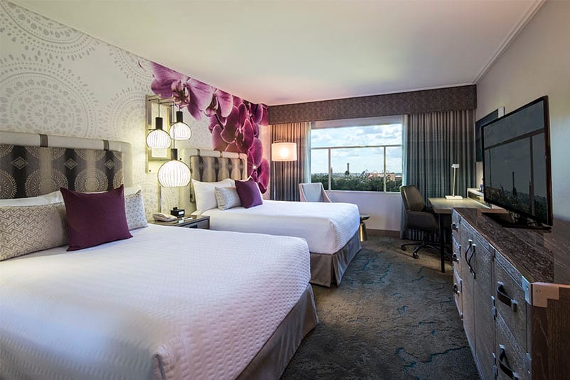 Guest Rooms at Loews Royal Pacific Resort in Universal Orlando offer a variety of settings, like garden and water views, all while maintaining a serene island feeling. Two queen beds inside a Guest Room at Loews Royal Pacific Resort, a preferred on site resort hotel at Universal Orlando.