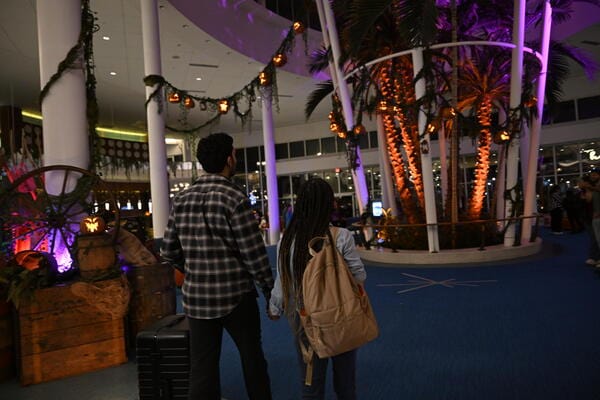 Couple walking into Cabana Bay Beach Resort with halloween themeing.