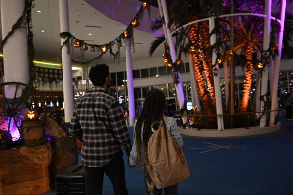 A couple walks into the lobby decorated for Halloween at Cabana Bay Beach Resort.