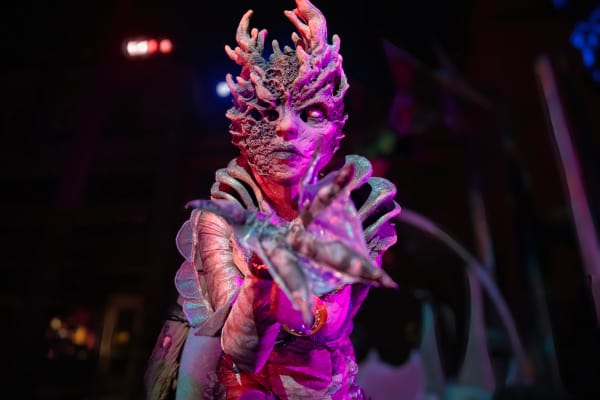 A demonic scareactor with coral-like bodily growths stalks a scare zone at Universal Halloween Horror Nights.