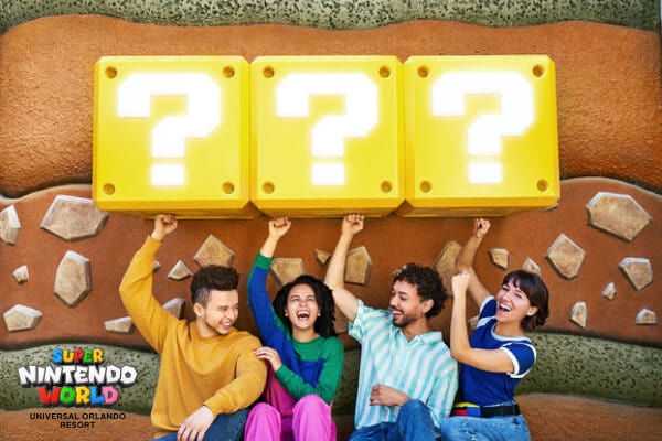 Guests at SUPER NINTENDO WORLD hitting a row of blocks