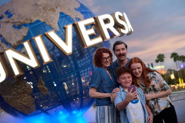 Family embracing in fron the Universal Orlando globe.