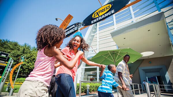 A family off our excitedly passes through an attraction's Express Entrance at Universal Studios Florida.