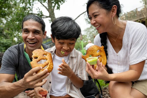 Family enjoying a Shrekzel with green cheese smeared on kids face