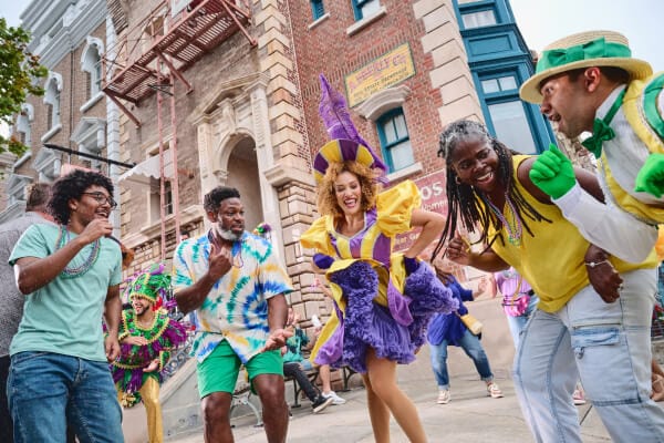Mardis Gras performers dancing with family