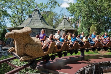 Young theme park guests and their families enjoying the mild roller coaster fun of Flight of the Hippogriff at The Wizarding World of Harry Potter in Universal's Islands of Adventure in Orlando.