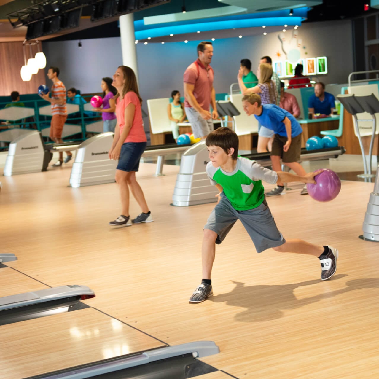 A little boy gets ready to roll a bowling ball at Galaxy Bowl inside Cabana Bay Beach Resort, an on site hotel at Universal Orlando. 