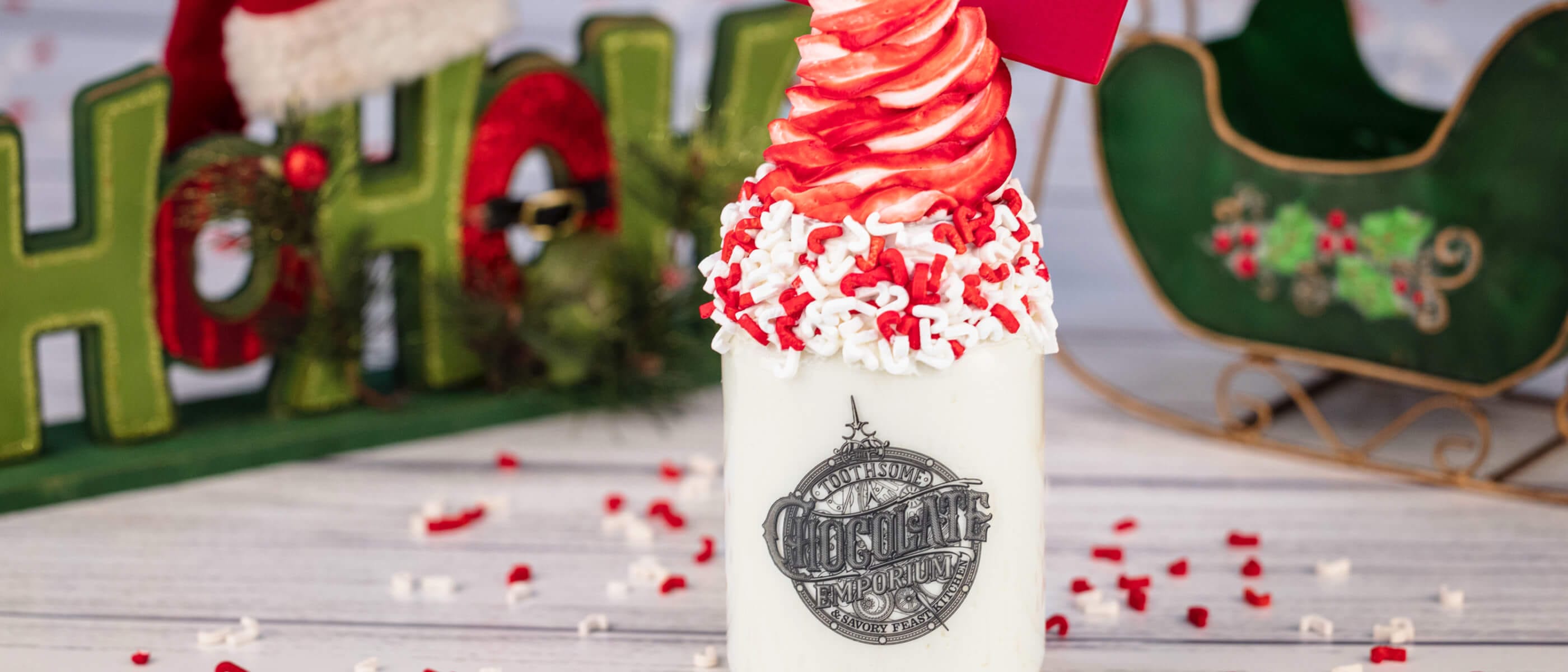 Decadent holiday milkshake with sprinkles and a red envelope topping from Toothsome Chocolate Emporium at CityWalk.