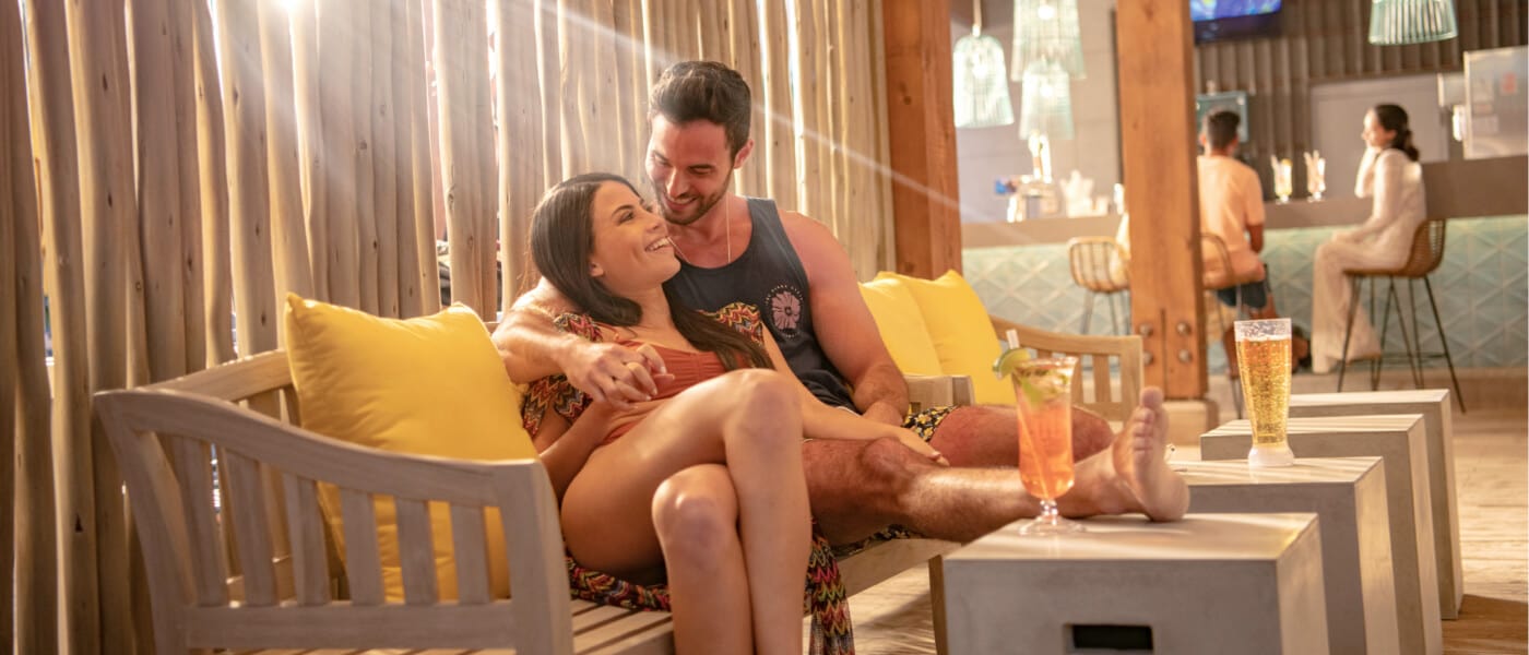 A couple enjoy some downtime at Oasis Beach Bar, the poolside bar of Universal's Endless Summer Resort - Dockside Inn and Suites.