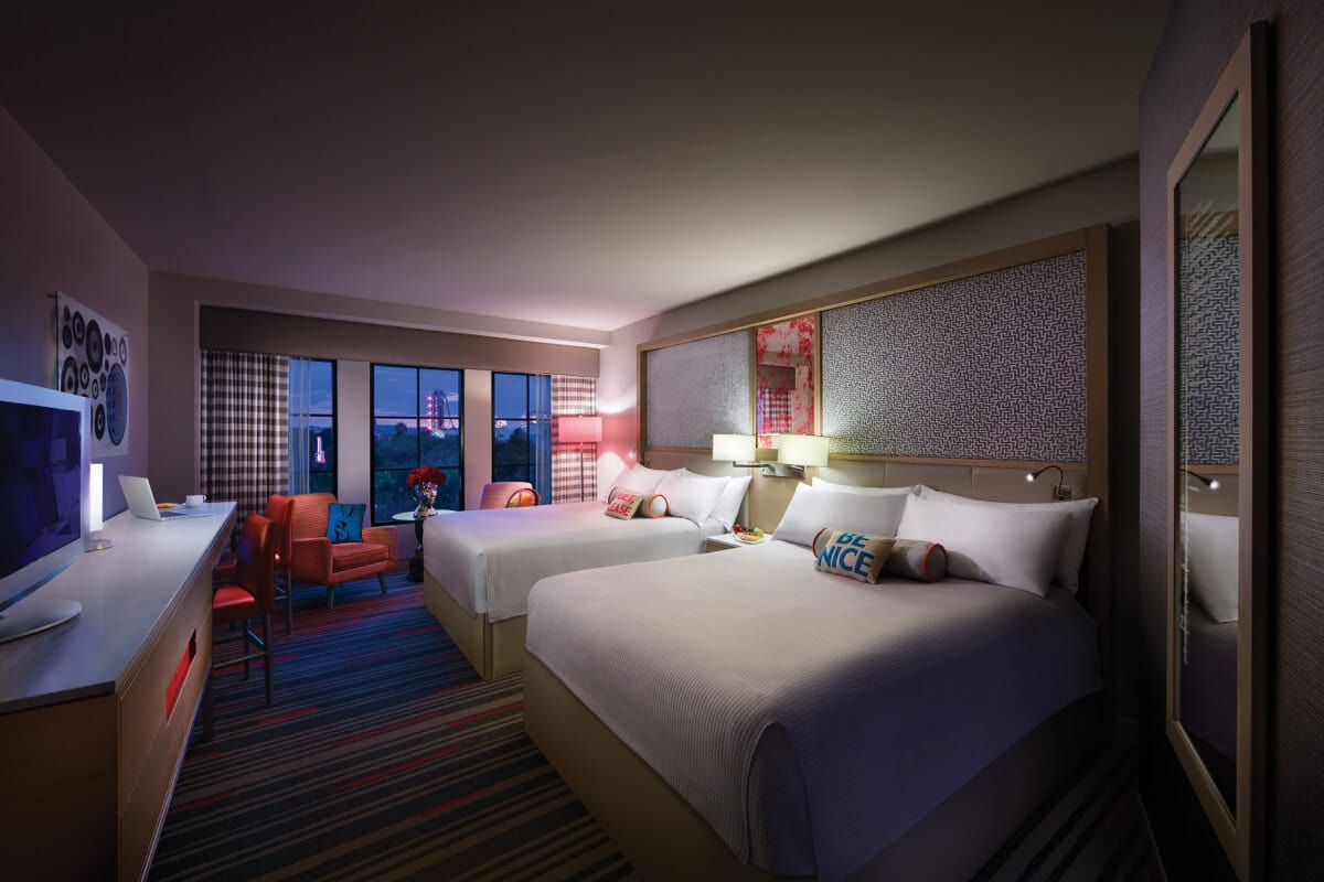 A nighttime interior view of a Guest Room with two Queen beds at Hard Rock hotel in Universal Orlando. 