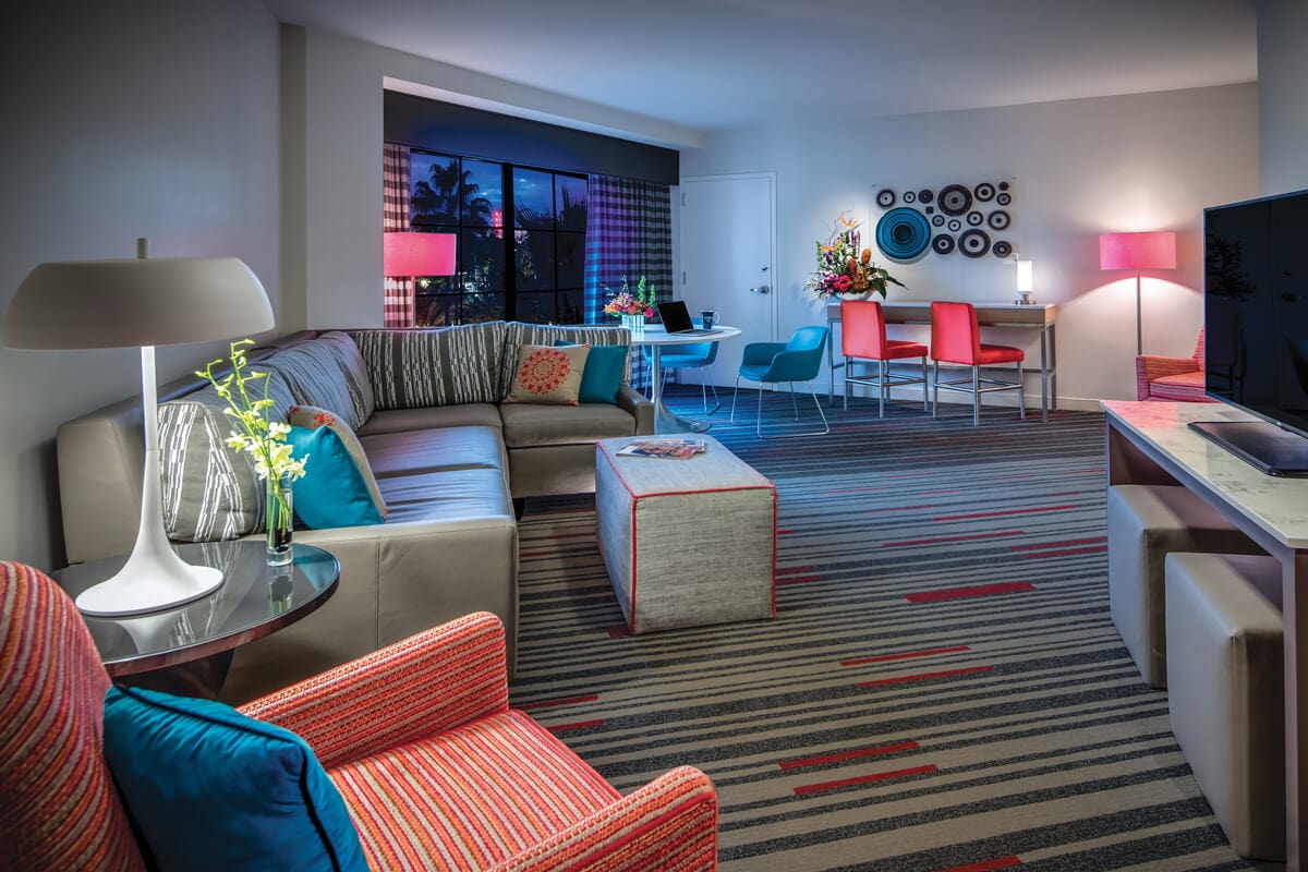 A view of the roomy sofa and lounge area with flat screen TV inside a Hard Rock Hotel King Suite. 