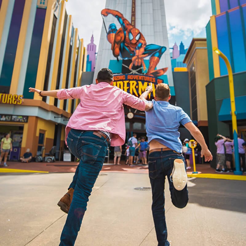 Guests run towards The Amazing Adventures of Spider-Man at Universal's Islands of Adventure.