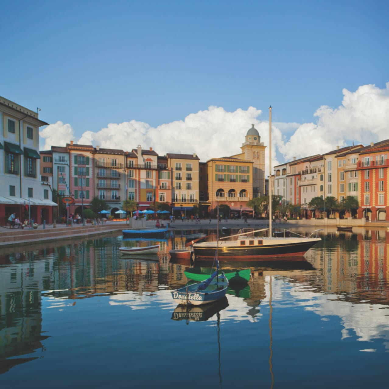 Boats floating in the water outside of the Loews Portofino Bay Hotel.