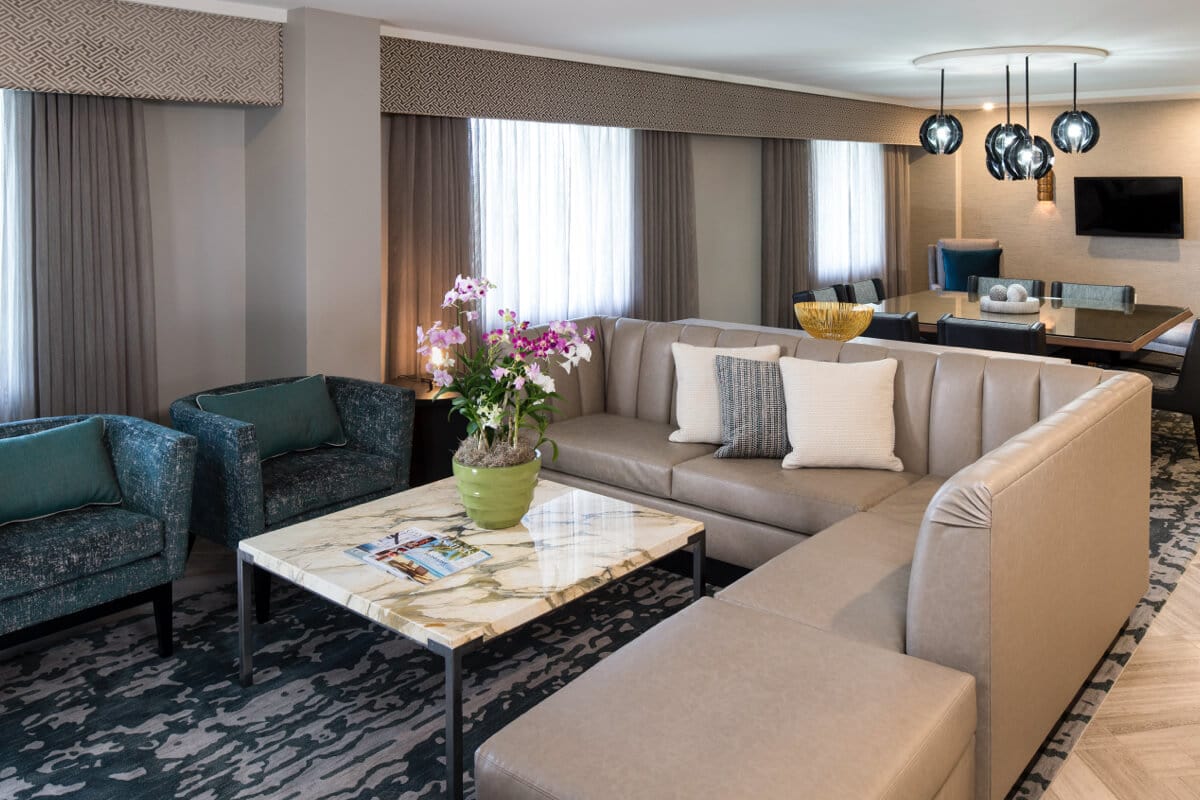 The couch and coffee table inside the spacious living room of the Captain's Presidential Suite at Loews Royal Pacific Resort.