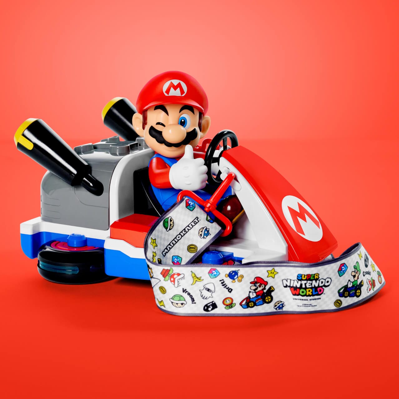 A popcorn bucket in the shape of Mario riding his Mario Cart, complete with a colorful lanyard, can be found at SUPER NINTENDO WORLD™ in Universal Epic Universe.
