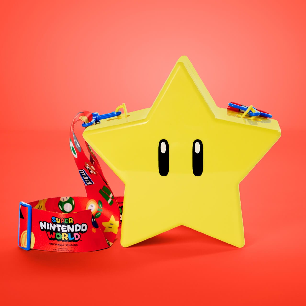 A yellow Super Star popcorn holder complete with a colorful lanyard can be found at SUPER NINTENDO WORLD™ in Universal Epic Universe.