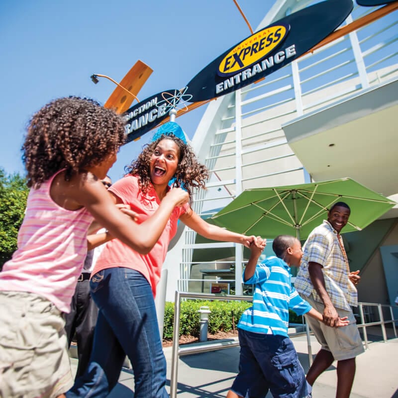 A family skips the regular lines, rushing toward the Universal Express ride entrance.