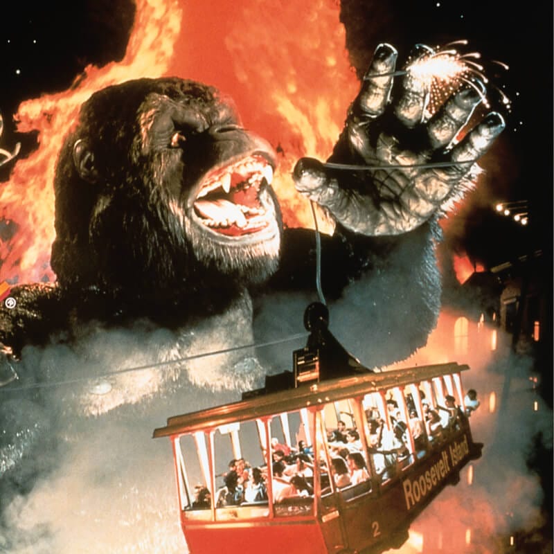 A cable car filled with guests is lifted by King Kong in retired Universal Orlando ride Kongfrontation.