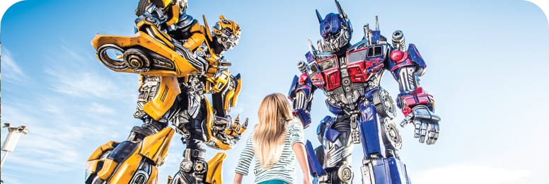 Girl staring up at transformers.