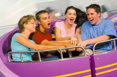 A group of guests working together to spin their ride vehicle on Storm Force Accelatron at Universal Orlando.
