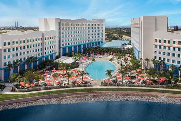 The two hotel towers of Universal’s Endless Summer – Surfside Inn and Suites with a large surfboard-shaped pool in between them.