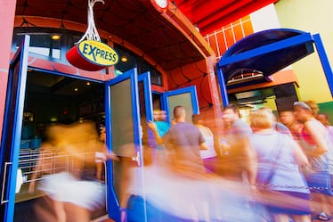 Guests file into a Universal Orlando attraction through the special Universal Express entrance. 