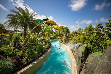 The Teawa Fearless River at Universal's Volcano Bay water theme park flows quickly and is lined with tropical landscaping.