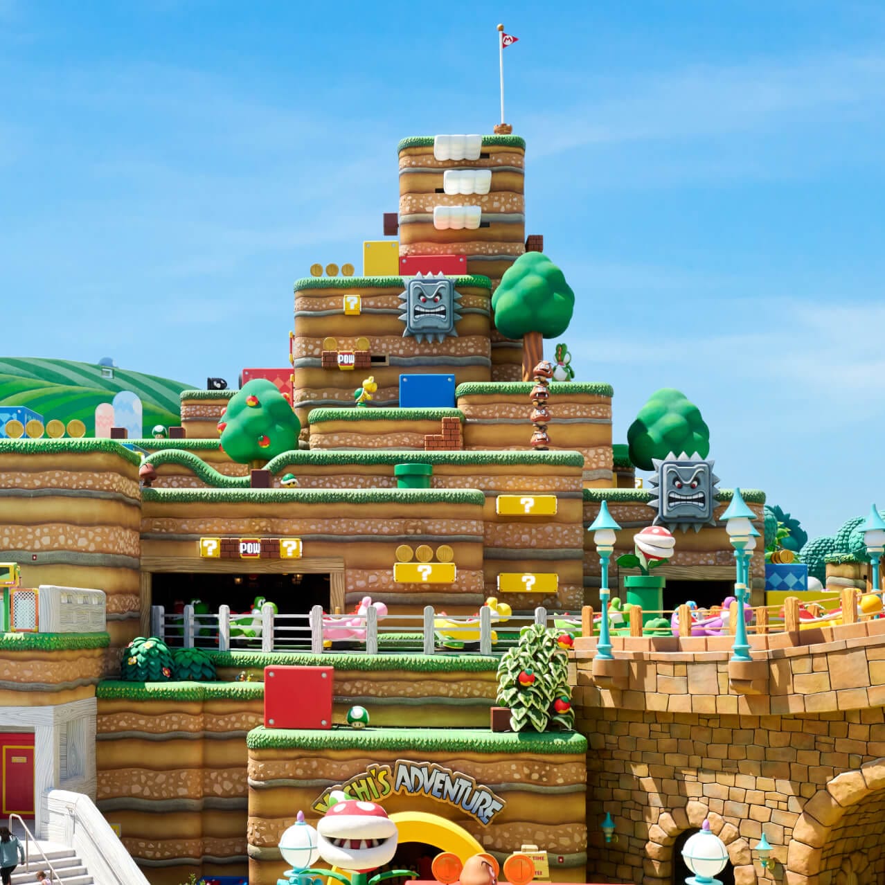 A group of four friends exchange smiles at SUPER NINTENDO WORLD™ at Universal Epic Universe.